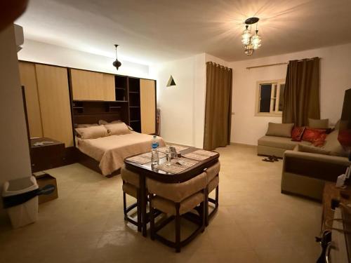 a bedroom with a bed and a table in a room at Mazari in Marsa Alam City