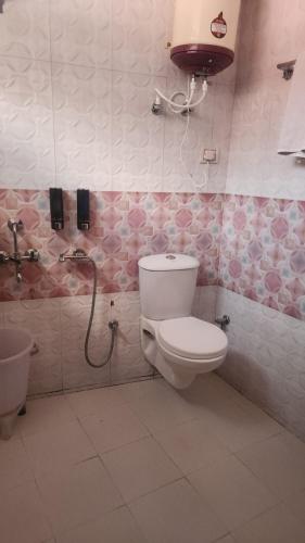 a bathroom with a toilet and a sink at ONHILLs in Mussoorie