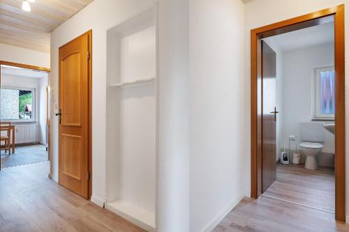 an empty hallway with a toilet and a door at Kleeblatt in Bad Wildbad