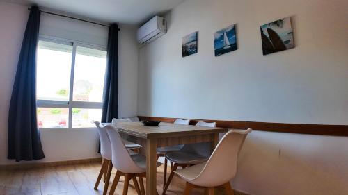 a dining room with a wooden table and chairs at Apartalux Calas Magic in Calasparra