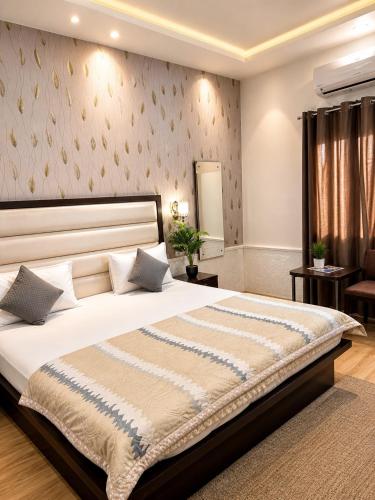 a bedroom with a large bed in a room at Sparkle Jaipur in Jaipur