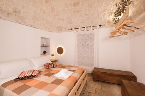 a bedroom with a large bed and a couch at Pavì Trulli e Suites in Locorotondo