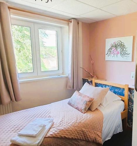 a bedroom with a bed with two towels on it at Abbaye de Belval in Troisvaux