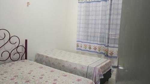 a bedroom with two beds and a window at Estação lazer e Eventos in Mairinque