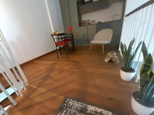 a living room with a wooden floor and a chair at casamiacasatua in Ronciglione