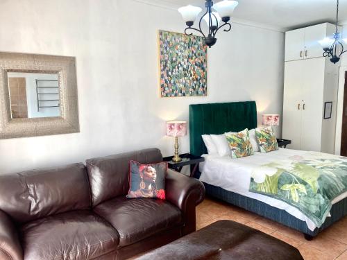 a living room with a couch and a bed at Franschhoek Mountain Escape in Franschhoek