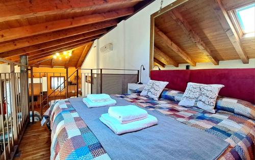 a bedroom with a large bed with pillows on it at open space apt - comodo a Venezia in Treviso