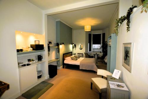 a hotel room with a bed and a living room at Crescent House in Plymouth