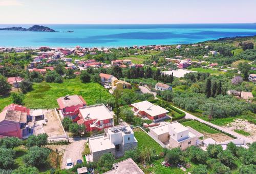 an aerial view of a village with houses and the ocean at Arillas Villas in Arillas
