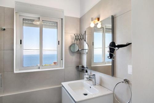 a bathroom with a sink and two windows at vv Rincón Solaris in Tijarafe