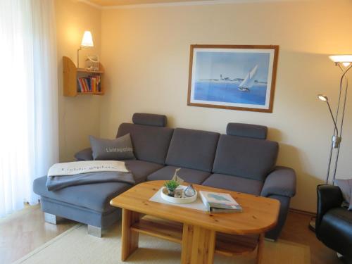 a living room with a couch and a coffee table at Ferienwohnung Bartels in Petersdorf mit Terrasse in Fehmarn