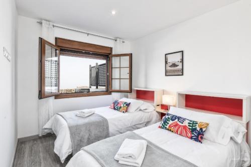 a bedroom with two beds and a window at vv Cerca Nueva in Las Manchas