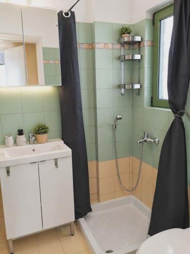 a bathroom with a shower and a sink at Sky Apartment in Katelios