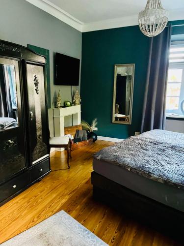 a bedroom with a bed and a tv on the wall at Casa Hauth in Bernkastel-Kues