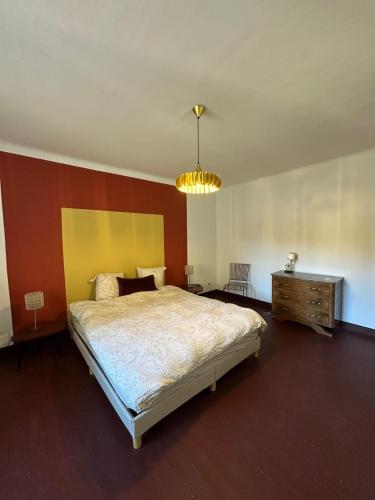 a bedroom with a large bed and a chandelier at Another World Village house in Buis-les-Baronnies