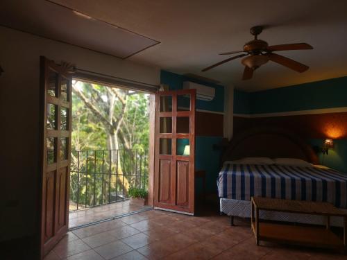 a bedroom with a bed and a ceiling fan at Don Pablo bed and breackfast in Copán Ruinas