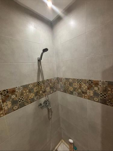 a bathroom with a shower with a toilet in it at Chambre avec WC privée pr 1p dans un appart partagé avec 1p in Sidi Maarouf