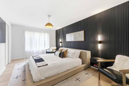 a bedroom with a large bed and a black wall at Sunset on Pokagon in Michiana