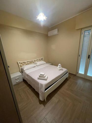a bedroom with a bed and a window at Il fico in Bovalino Marina