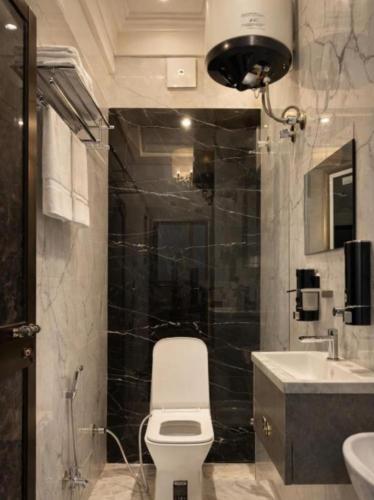 a bathroom with a toilet and a sink at Royal Awadh Inn in Ayodhya