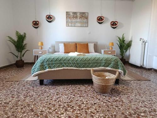 a bedroom with a bed and a basket in it at Themistoklis house in Koropi