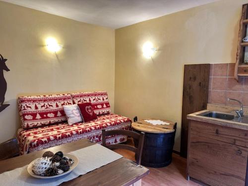 a living room with a couch and a table at La Peiro Douco in Roure Turin