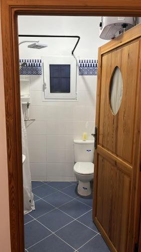 a bathroom with a toilet and a window at Dar Said Marrakech in Lalla Takerkoust
