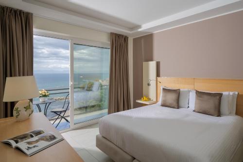 a hotel room with a bed and a large window at Grand Hotel Santa Maria in Santa Maria di Castellabate