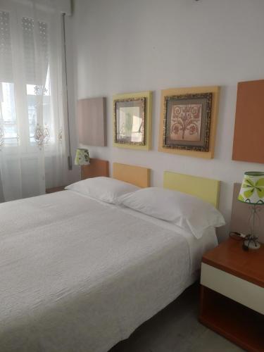 a bedroom with a large white bed and a window at Affittacamere La Spezia Inn in La Spezia