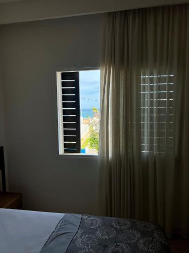a bedroom with a window with a view of the ocean at Visit Chamal - Horizon View in Oued Laou