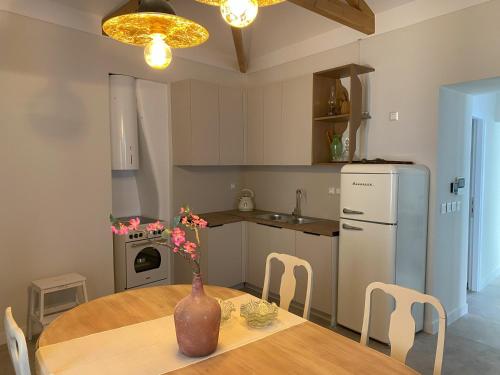 a kitchen with a table with a vase on it at Hercules Historic Apartments in Chalkida