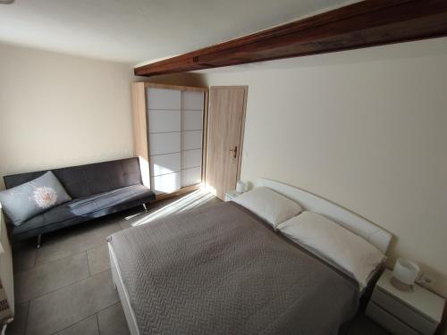 a room with a bed and a couch in it at Apartma Silvester in Bovec