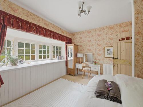 a living room with a couch and a desk at The Archway Suite in Peebles