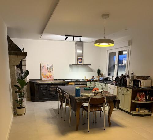 a kitchen with a table and some chairs in a room at Casa Rural Picape in Pedre