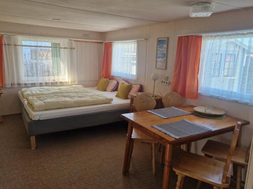a bedroom with a bed and a desk and a table sidx sidx sidx at Mobilheim am Hafen in Gager