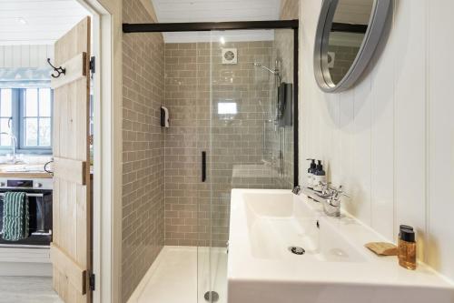a bathroom with a sink and a shower at Bankhead Shepherds Hut in Stirling