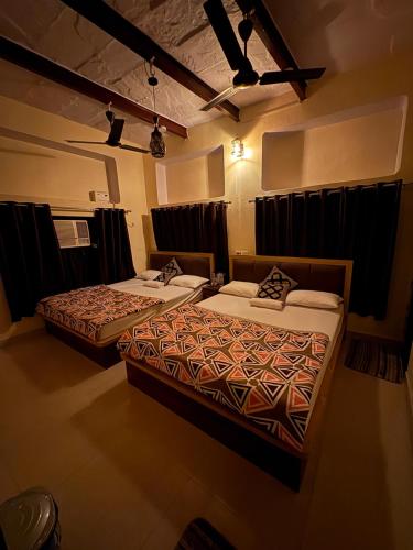two beds in a hotel room with at Stay in Someshwar in Varanasi