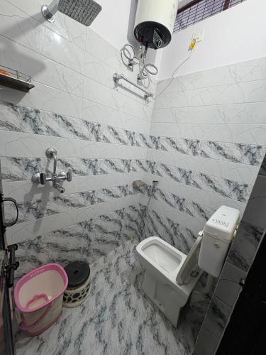 a bathroom with a toilet and a sink at Stay in Someshwar in Varanasi