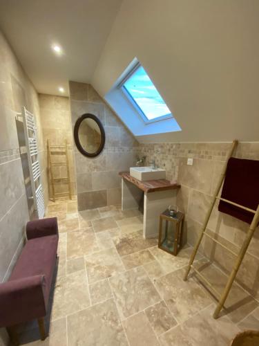 a bathroom with a sink and a skylight at Le Cocooning in Asnières