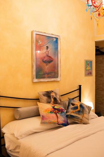 a bedroom with a bed with a painting on the wall at Domus Mazzini in Tivoli