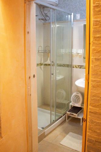 a glass shower in a bathroom with a sink at Domus Mazzini in Tivoli