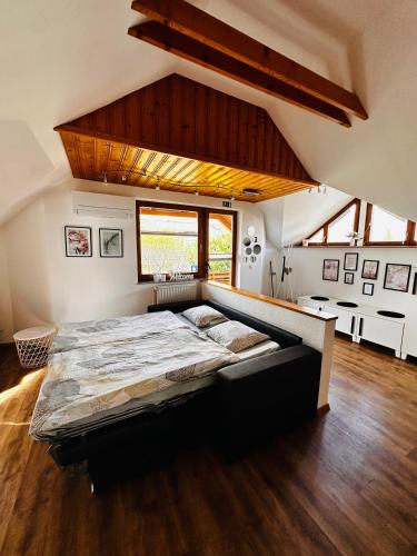 a bedroom with a large bed in a room at Lusht'n apartma in Žirovnica