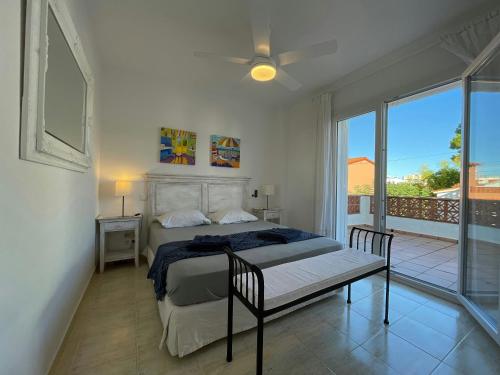 a bedroom with a bed and a balcony at Villa Riells Mar in L'Escala