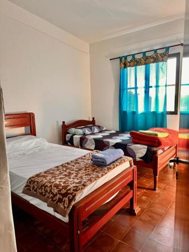 a bedroom with two beds and a window at El Descanso APART in Libertador General San Martín