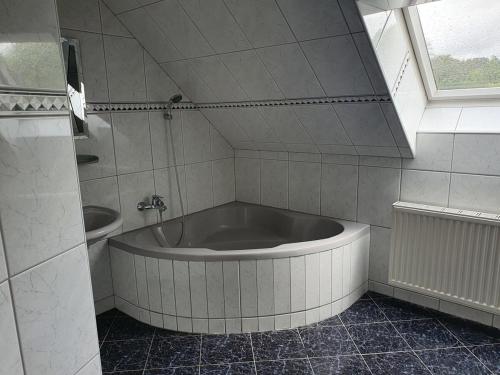 a large tub in a bathroom with a window at Ferienwohnung Wiener in Marchtring