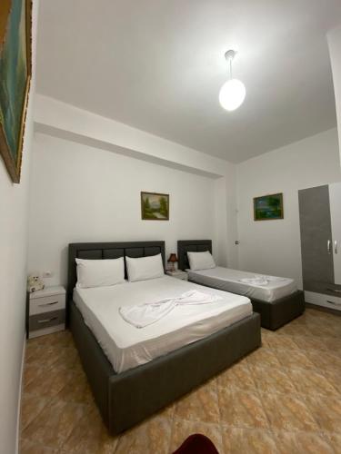 a bedroom with two beds in a room at Guesthouse SELI in Berat