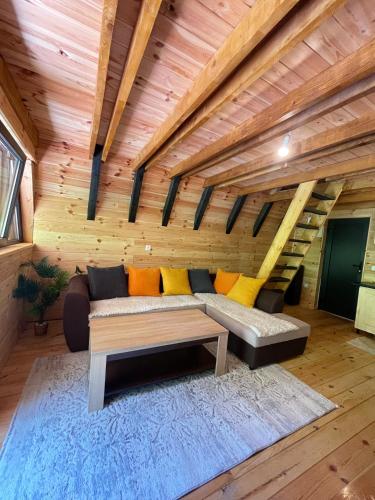 a living room with a couch and a table at A&R cottages in Vusanje