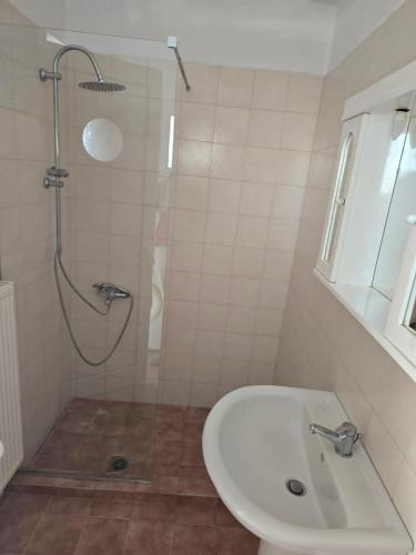 a white bathroom with a shower and a sink at Nature & Sea Paradise in Analipsi in Análipsis