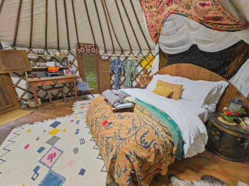 a bedroom with a bed in a tent at Esk Yurt in Drummelzier