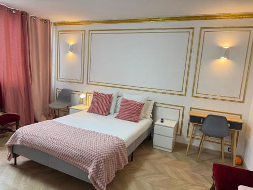 a bedroom with a large bed with pillows and avertisement at SCI IMMO PARIS PORTE DE CHOISY in Paris